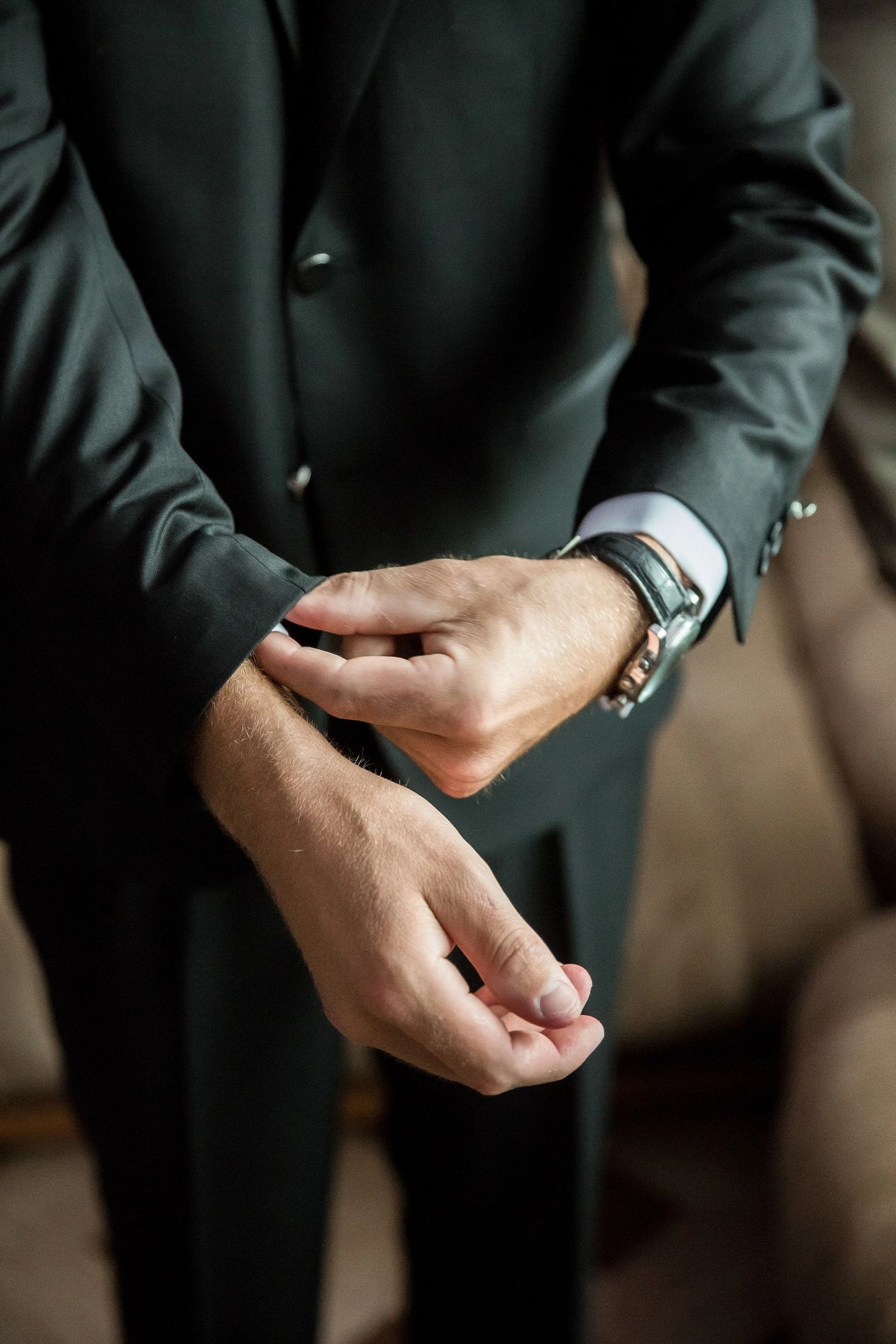 Luxury watch worn with a tailored suit